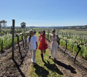 Three girls enjoying a glass of Shiraz-Rose amongst the vines where the fruit was grown.