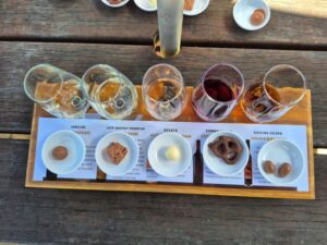 Showing a board with 5 special chocolates paired with 5 wines in stemless glasses.